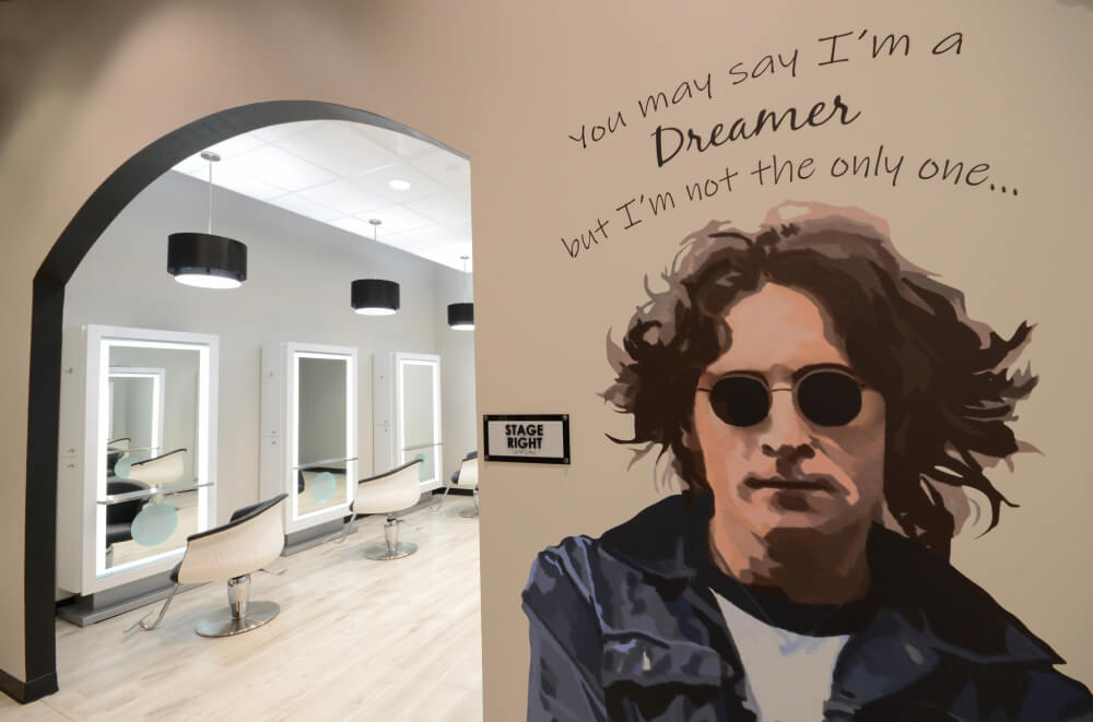 - Studio Wish Salon Spa in Twinsburg, OH A mural of a person in sunglasses with the text "You may say I’m a Dreamer but I'm not the only one..." is painted on a wall near salon chairs and mirrors, creating an inspiring vibe in this luxury salon spa. - Studio Wish Salon Spa in Twinsburg, OH